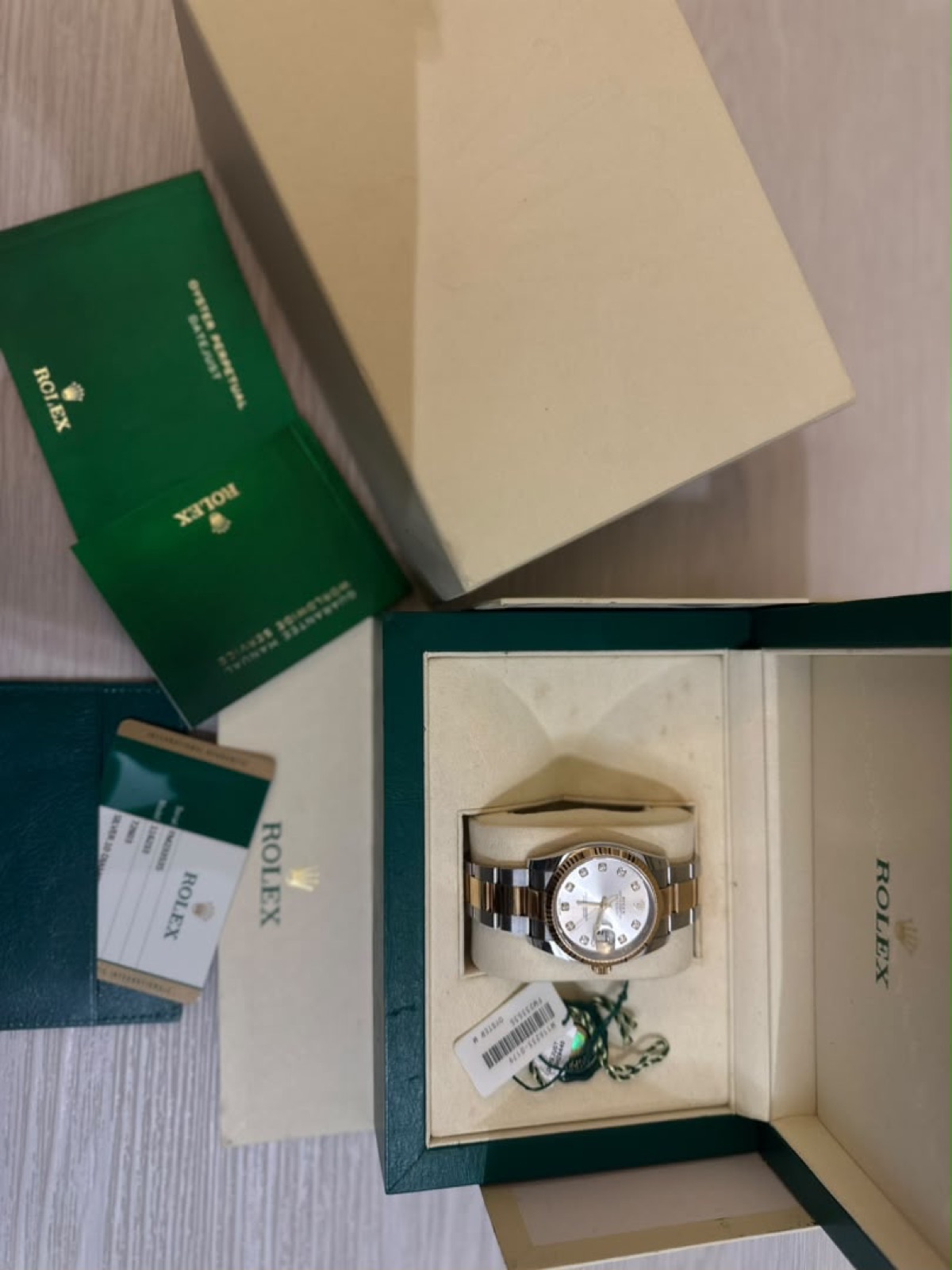 Rolex Datejust, full set with box and card, held in hand
